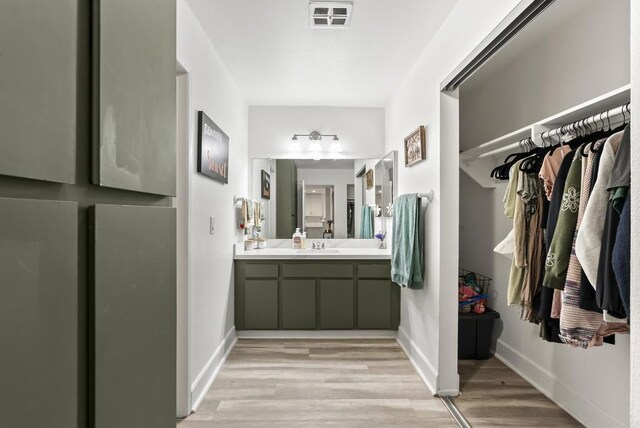 6780 Friars Rd Unit 243, San Diego, CA 92108 - bathroom with wood finished floors, vanity, and a spacious closet