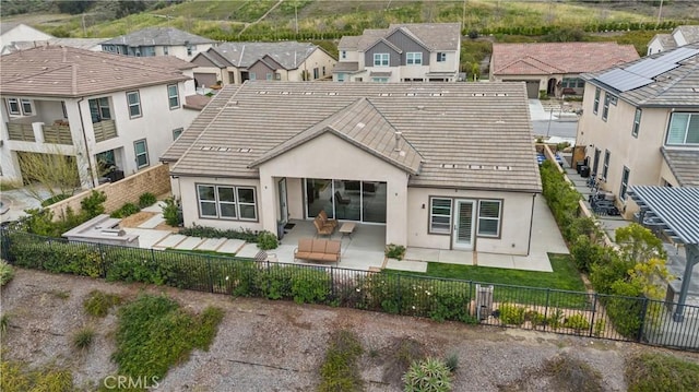 rear view of house featuring a fenced backyard, a patio area, stucco siding, and a residential view