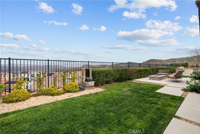 view of yard featuring a patio, a fire pit, and fence
