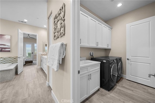 washroom featuring ceiling fan, cabinet space, light wood finished floors, recessed lighting, and washer and dryer