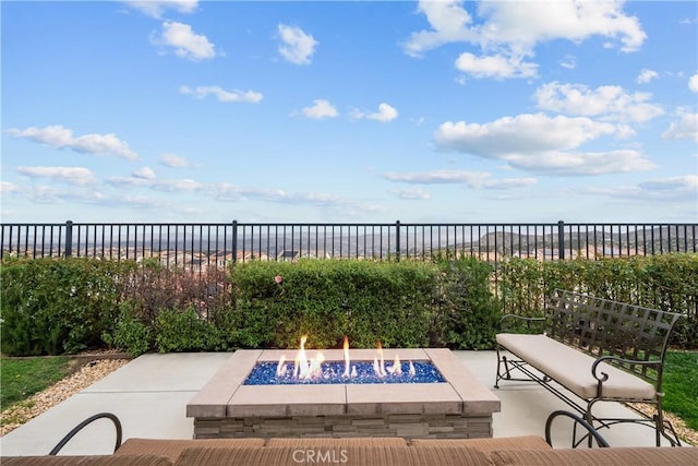 view of patio / terrace featuring fence and a fire pit