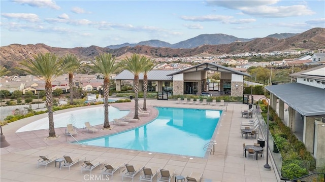pool with a patio and a mountain view