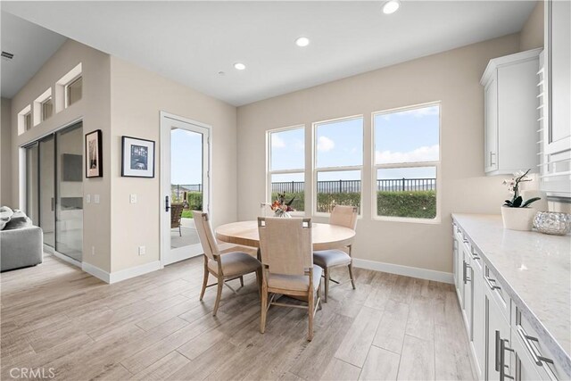 dining room featuring baseboards, recessed lighting, light wood-style flooring, and visible vents