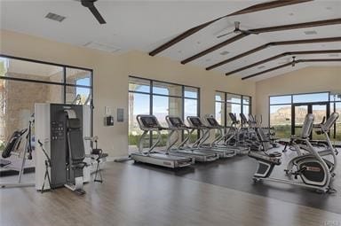 workout area with ceiling fan, vaulted ceiling, wood finished floors, and visible vents