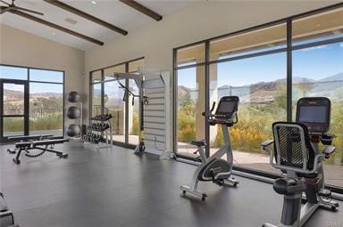 workout area with a ceiling fan and vaulted ceiling