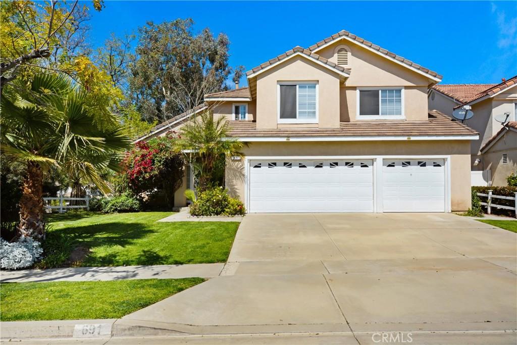 691 Country Rose Ln, Corona, CA 92882 - view of front facade featuring a front lawn, a tile roof, a garage, and concrete driveway
