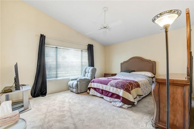 carpeted bedroom featuring a ceiling fan and vaulted ceiling