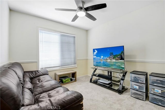 carpeted living room featuring a ceiling fan