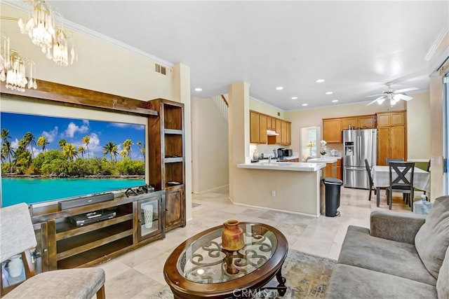 living area with ornamental molding, visible vents, recessed lighting, and ceiling fan with notable chandelier