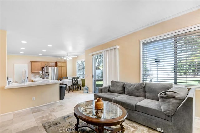 living area with recessed lighting, ceiling fan, ornamental molding, and light tile patterned floors