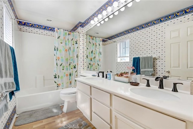 full bath with wood finished floors, toilet, a sink, and shower / bath combo with shower curtain
