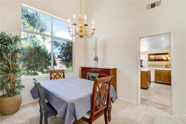 dining space with baseboards, visible vents, and an inviting chandelier