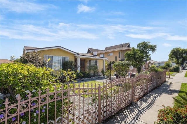 view of front of property with stucco siding and fence