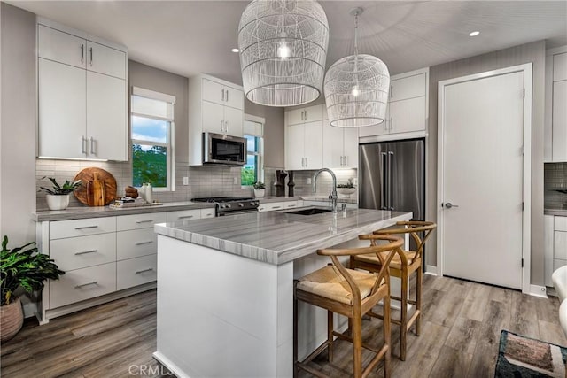 2524 Everly Dr, San Diego, CA 92108 - kitchen featuring white cabinetry, a sink, light wood-style flooring, backsplash, and stainless steel appliances