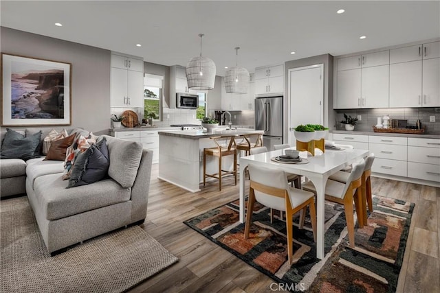 2524 Everly Dr, San Diego, CA 92108 - kitchen with a sink, stainless steel appliances, recessed lighting, decorative backsplash, and light wood-type flooring