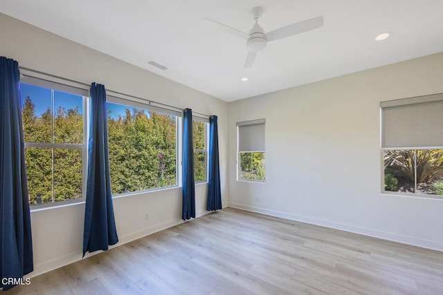unfurnished room featuring recessed lighting, visible vents, a ceiling fan, baseboards, and light wood-style flooring