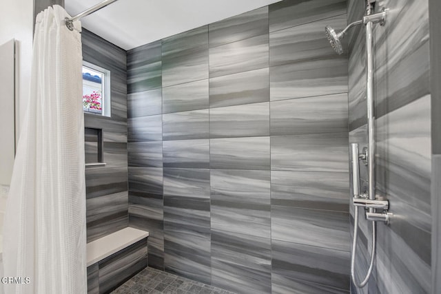full bathroom with tiled shower