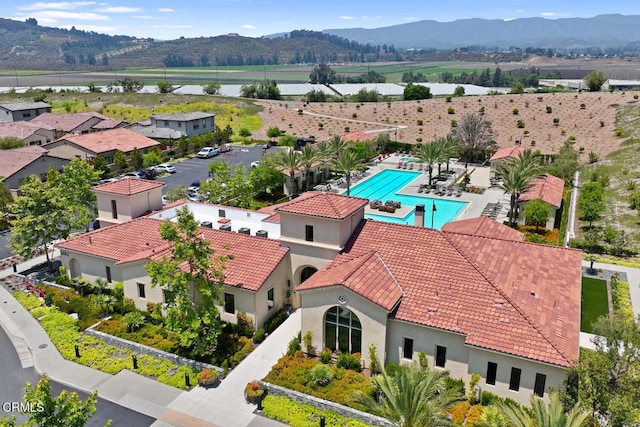 birds eye view of property featuring a water and mountain view