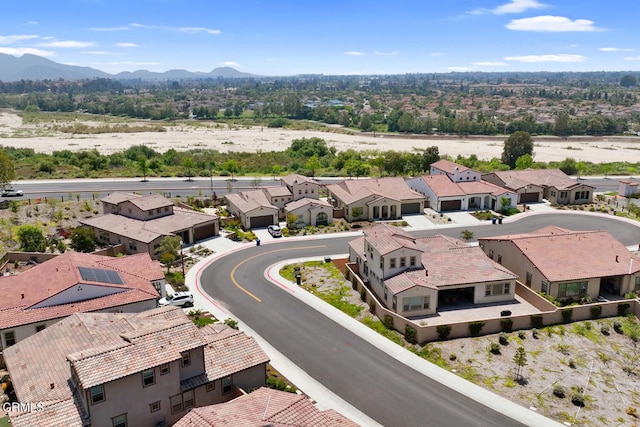 birds eye view of property with a mountain view and a residential view