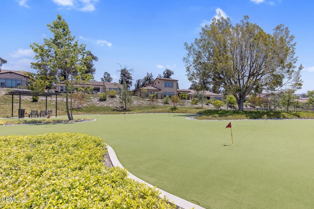 view of property's community featuring a pergola, fence, and a residential view