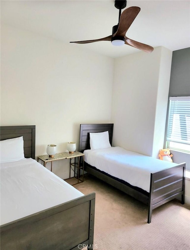 carpeted bedroom with a ceiling fan