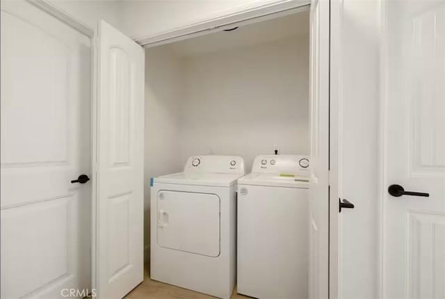 clothes washing area featuring washing machine and dryer and laundry area