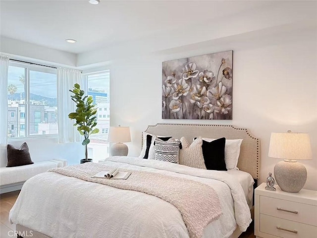 bedroom with wood finished floors and recessed lighting