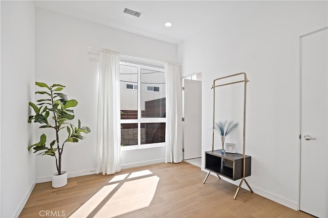 interior space featuring baseboards, visible vents, light wood-style flooring, and recessed lighting