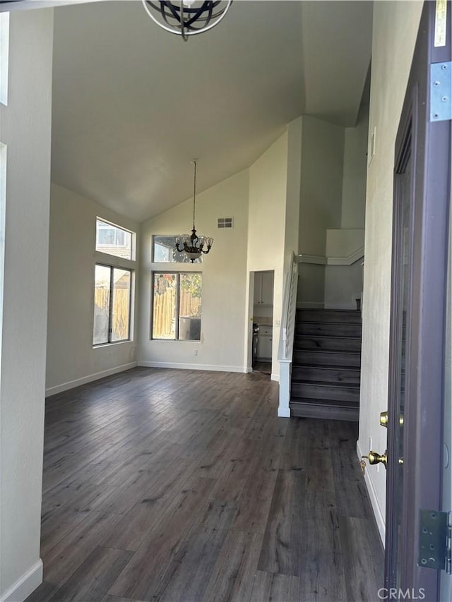 interior space with high vaulted ceiling, stairway, a chandelier, dark wood finished floors, and baseboards