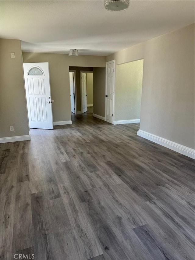 518 E 2nd St, Rialto, CA 92376 - empty room featuring baseboards and dark wood-type flooring