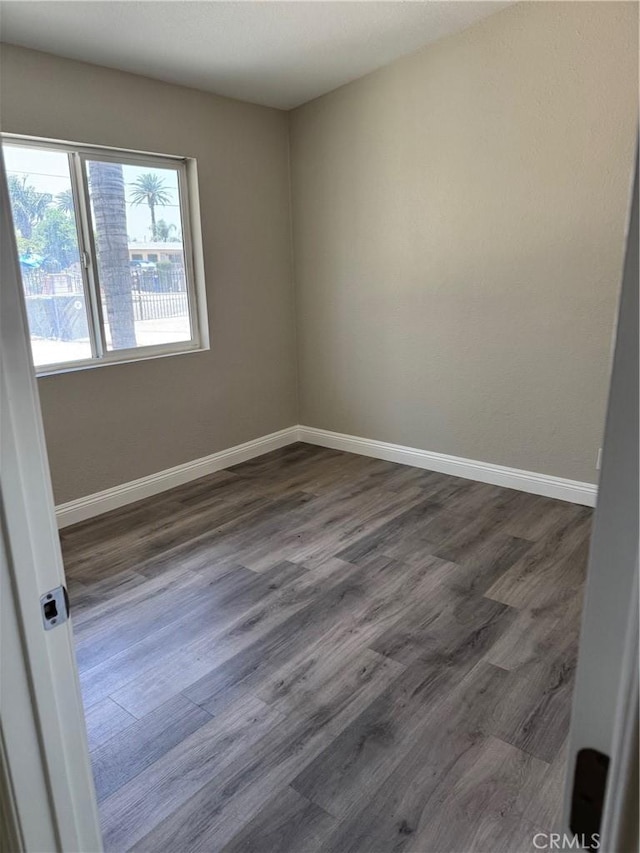 518 E 2nd St, Rialto, CA 92376 - empty room featuring baseboards and dark wood-style flooring