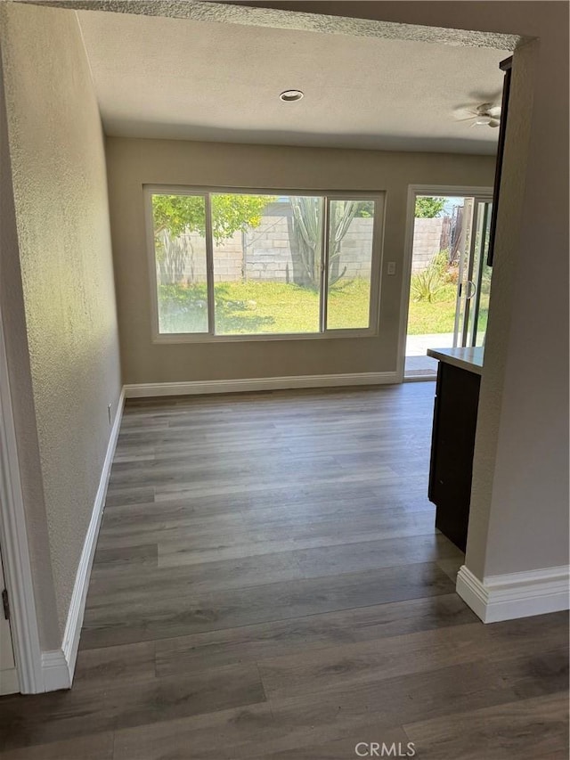 518 E 2nd St, Rialto, CA 92376 - empty room with wood finished floors, a textured wall, a textured ceiling, and a ceiling fan