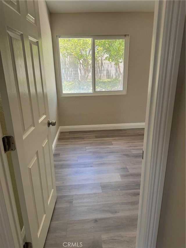 518 E 2nd St, Rialto, CA 92376 - unfurnished room with healthy amount of natural light and wood finished floors