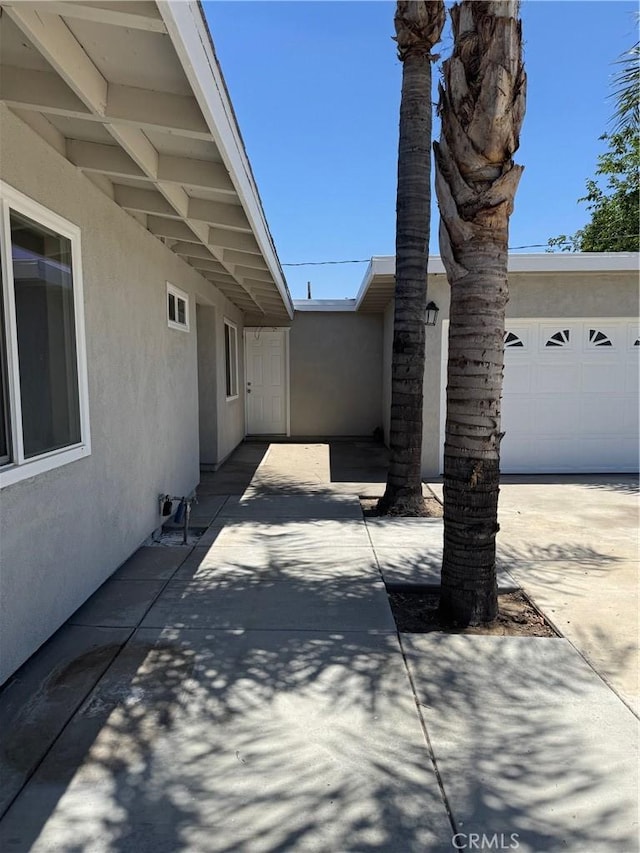 518 E 2nd St, Rialto, CA 92376 - view of patio featuring an attached garage