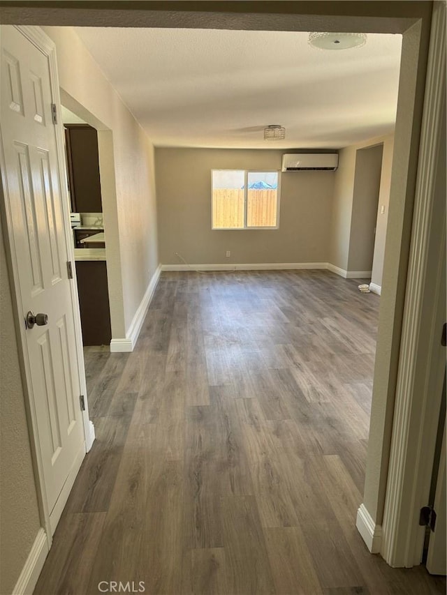 518 E 2nd St, Rialto, CA 92376 - unfurnished room with a wall mounted air conditioner and wood finished floors