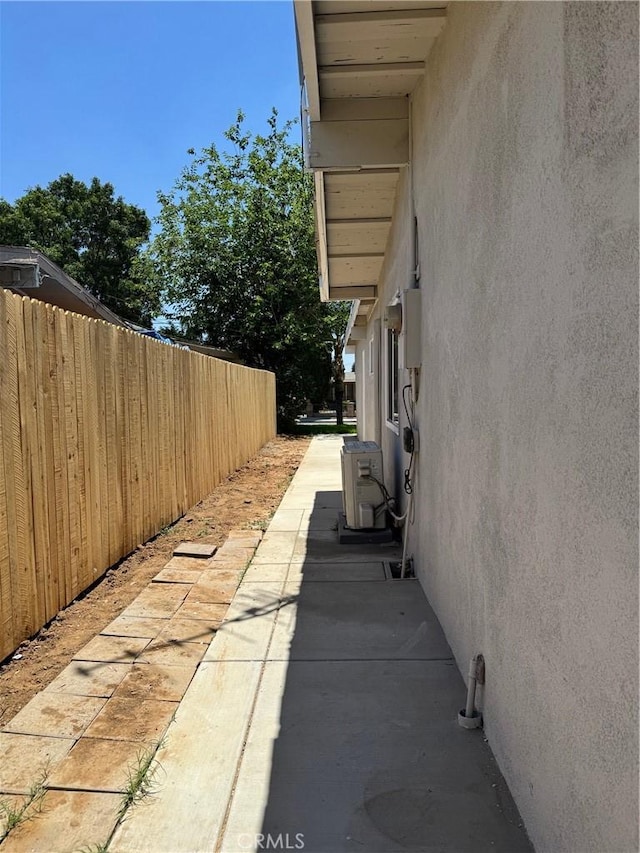 518 E 2nd St, Rialto, CA 92376 - view of side of property featuring stucco siding and a cooling unit