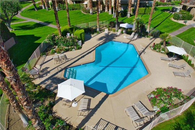 pool with fence and a patio
