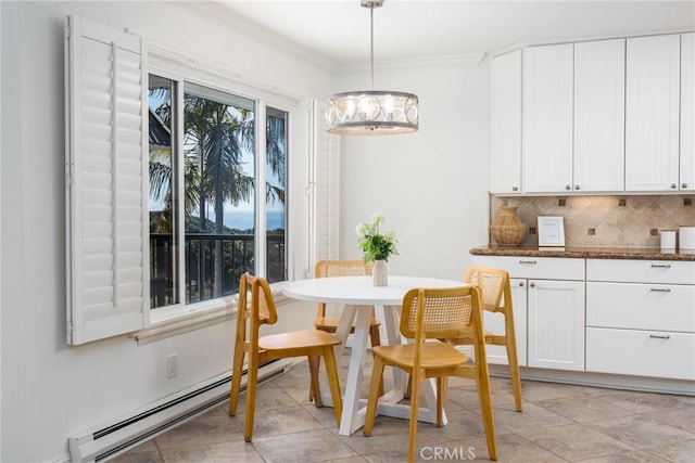 dining space with an inviting chandelier, ornamental molding, and a baseboard radiator