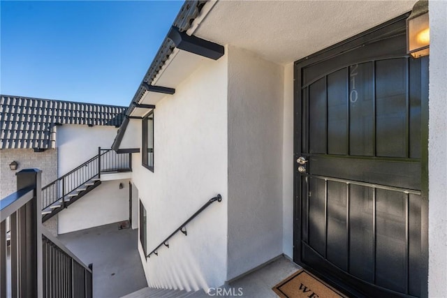 doorway to property with stucco siding