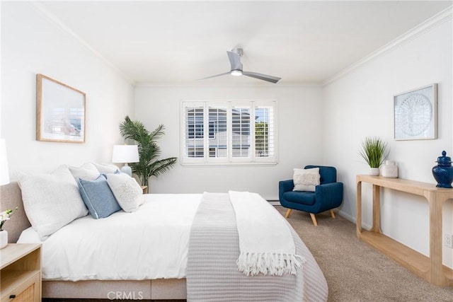 carpeted bedroom with ornamental molding and a ceiling fan