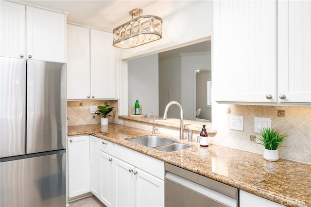 kitchen with white cabinetry, light stone counters, a sink, backsplash, and stainless steel appliances