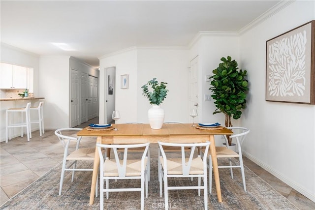 dining room with baseboards and ornamental molding