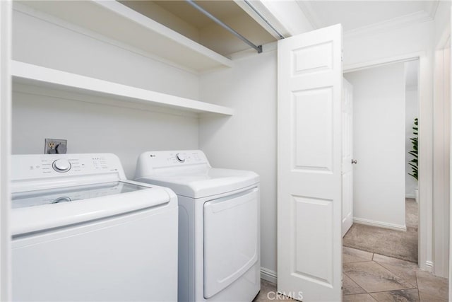 washroom featuring laundry area, independent washer and dryer, crown molding, baseboards, and light carpet