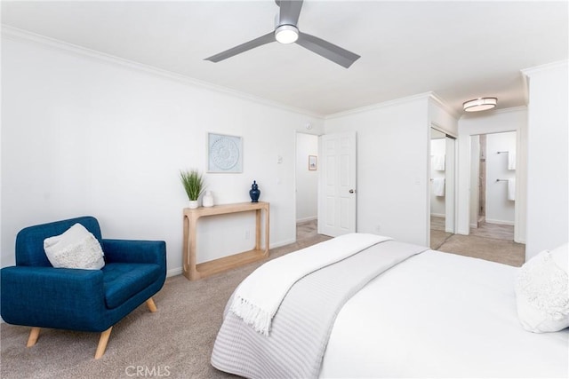 carpeted bedroom with ornamental molding, a closet, ensuite bath, and ceiling fan