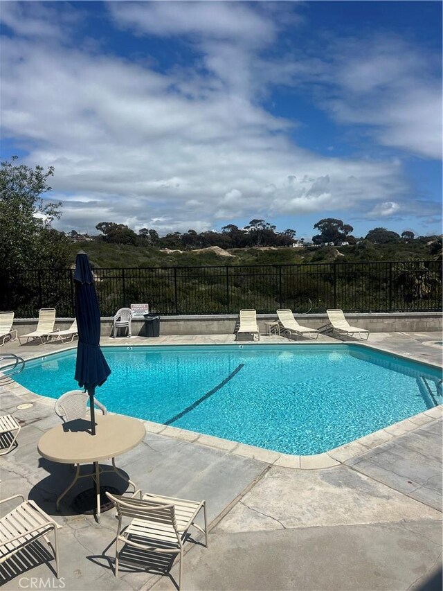 pool featuring a patio and fence