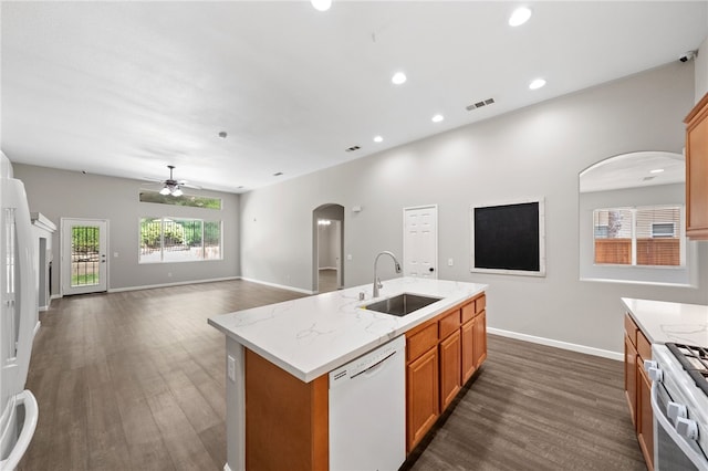 24898 Sunset Vista Ave, Menifee, CA 92584 - kitchen with a sink, white appliances, arched walkways, dark wood-style flooring, and a ceiling fan