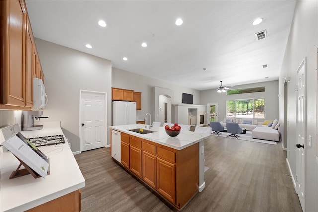 24898 Sunset Vista Ave, Menifee, CA 92584 - kitchen featuring a sink, ceiling fan, white appliances, dark wood finished floors, and brown cabinets