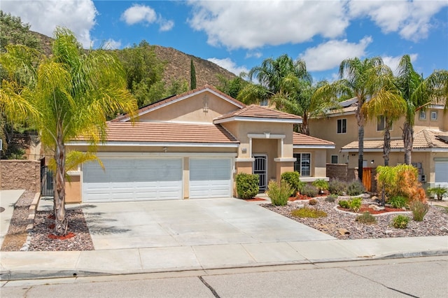 24898 Sunset Vista Ave, Menifee, CA 92584 - view of front of house with a garage, driveway, stucco siding, a tile roof, and a mountain view