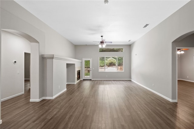 24898 Sunset Vista Ave, Menifee, CA 92584 - unfurnished living room featuring ceiling fan, arched walkways, and dark wood finished floors