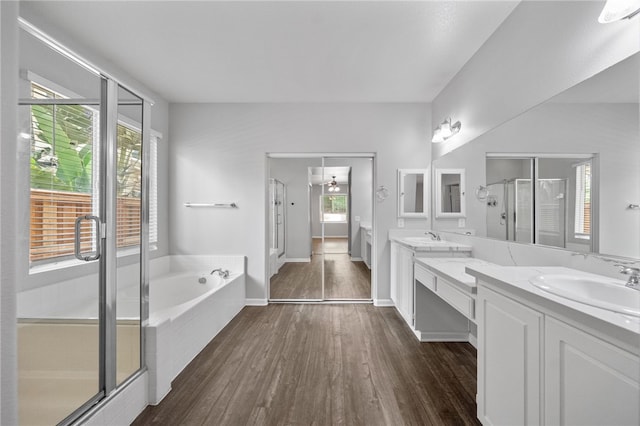24898 Sunset Vista Ave, Menifee, CA 92584 - full bath featuring double vanity, a stall shower, a garden tub, wood finished floors, and baseboards